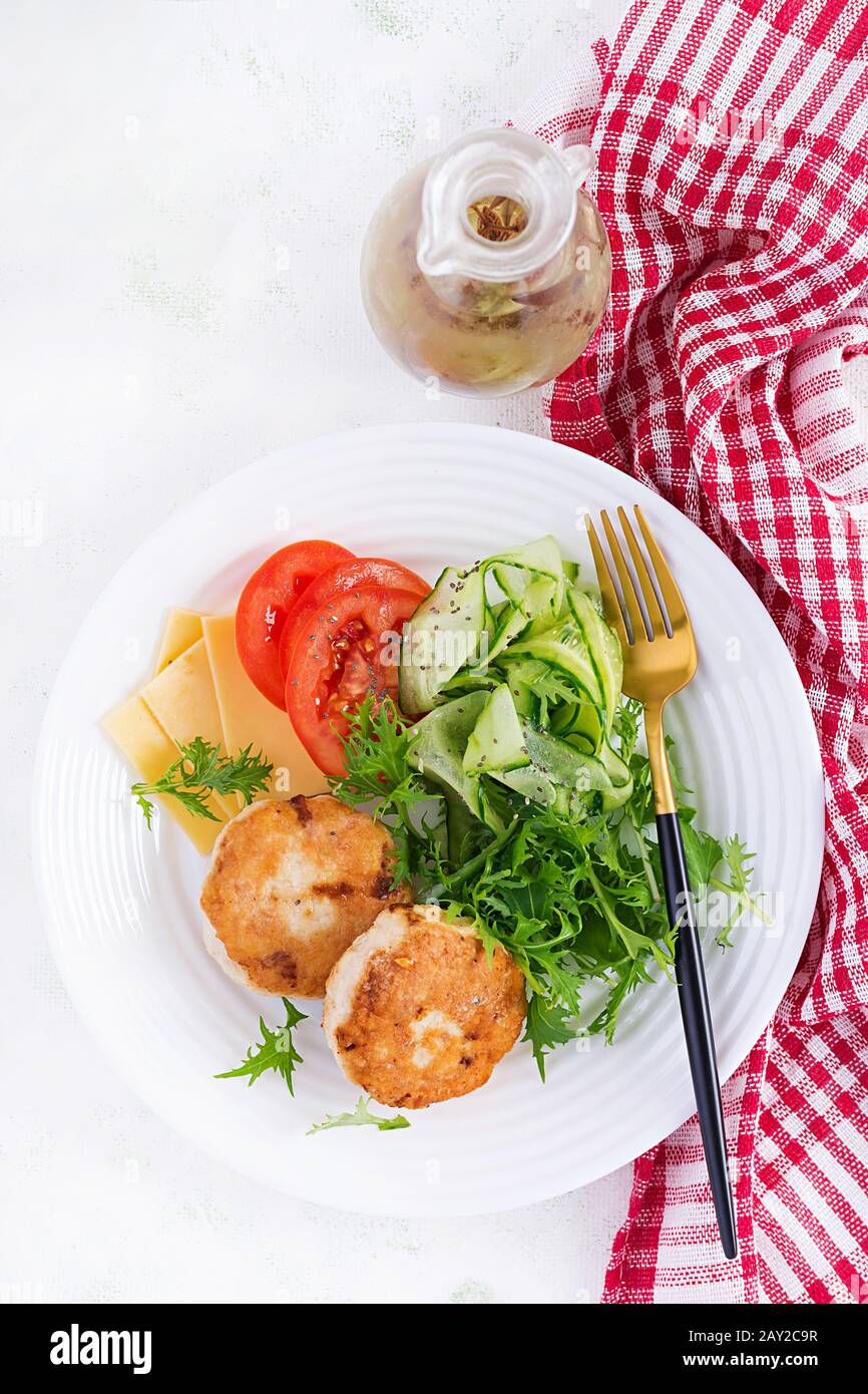 Ketogenic lunch. Chicken burger with tomato, cucumber, cheese and