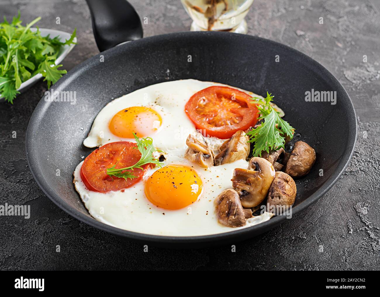 Ketogenic food. Fried egg, mushrooms and sliced tomatoes. Keto, paleo breakfast. Stock Photo
