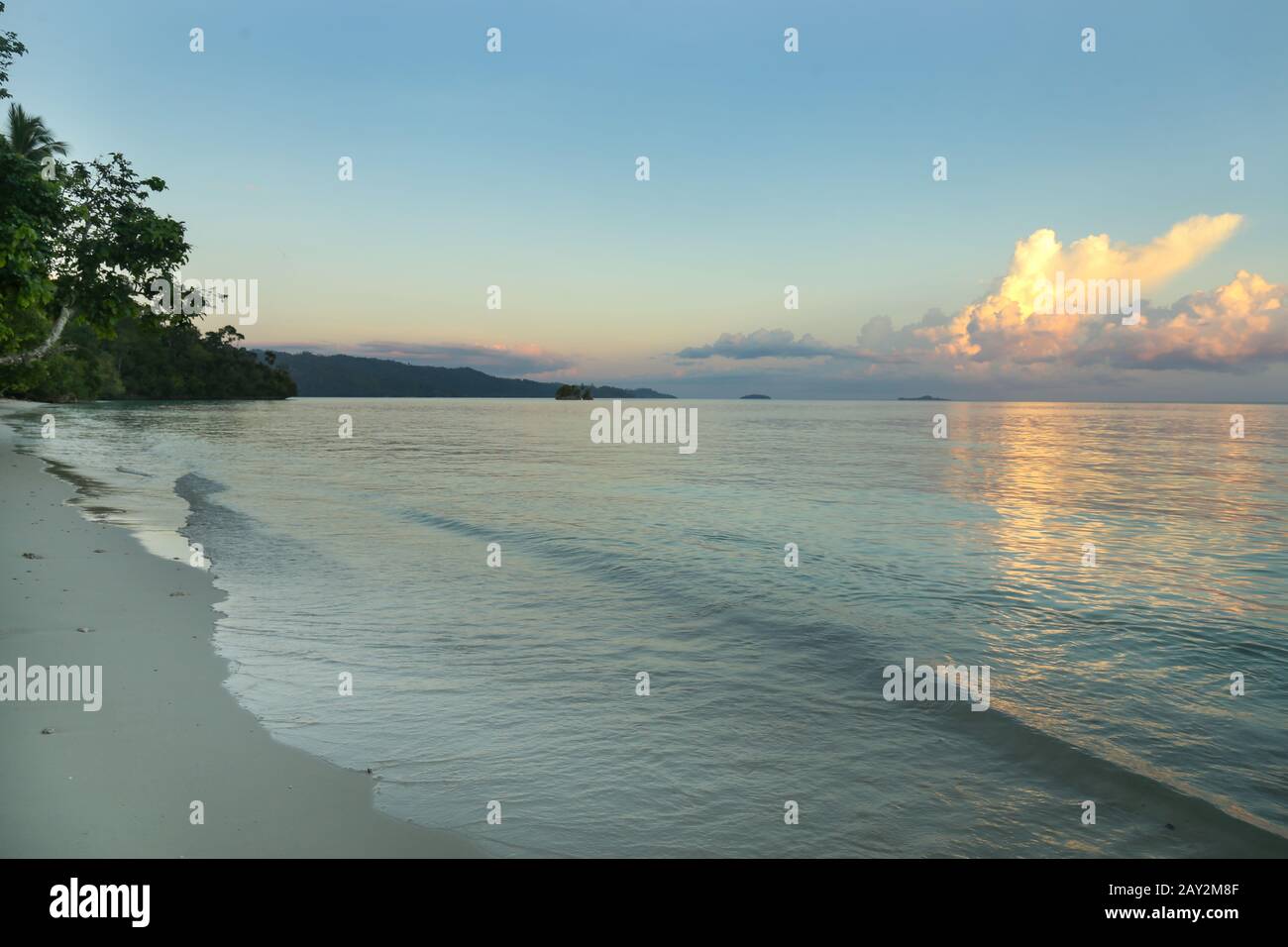 Beautiful view of a wild tropical beach during sunset. Raja Ampat Stock Photo