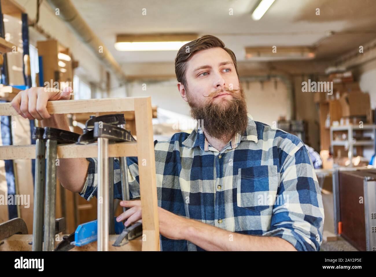 Hipster Carpenter as an independent craftsman in his carpentry Stock Photo