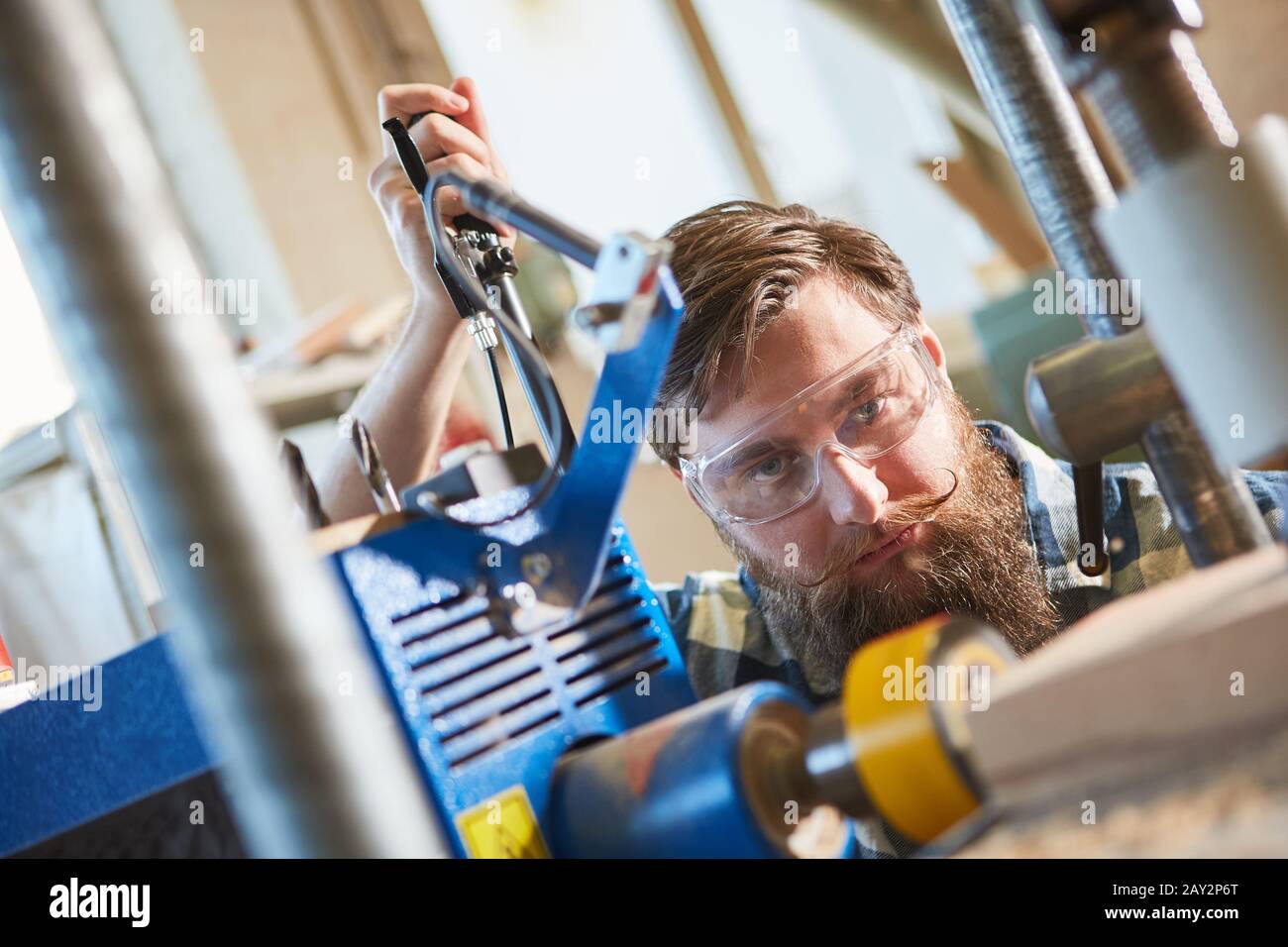 Carpenter with safety glasses when drilling wood with a drill with laser display Stock Photo Alamy