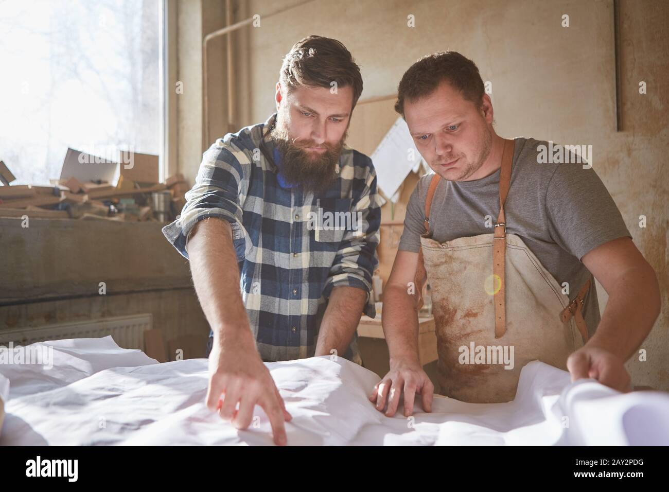 The architect and carpenter work together as a team in the construction planning Stock Photo