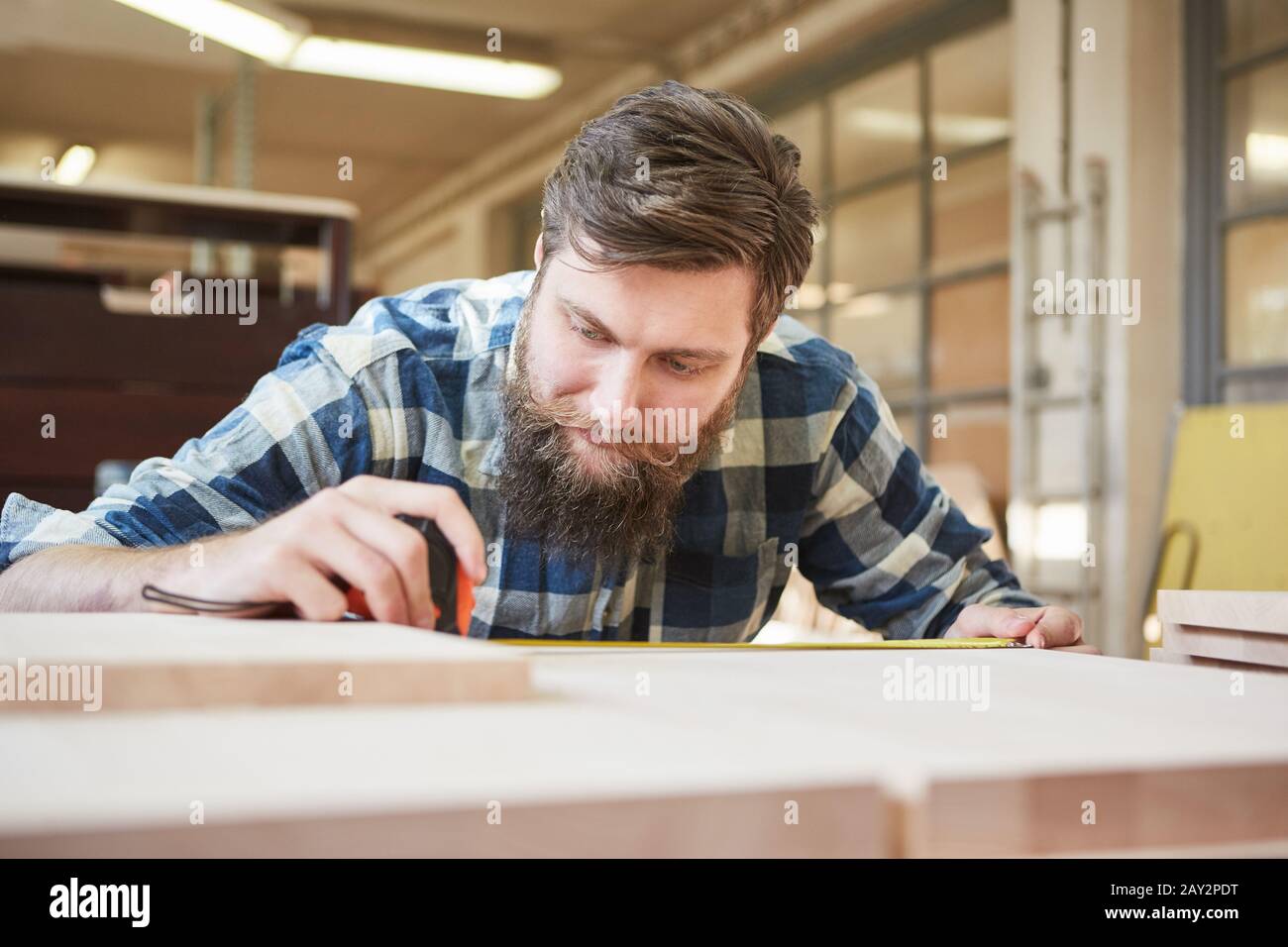 Hipster carpenter training as a furniture maker building shelves Stock Photo