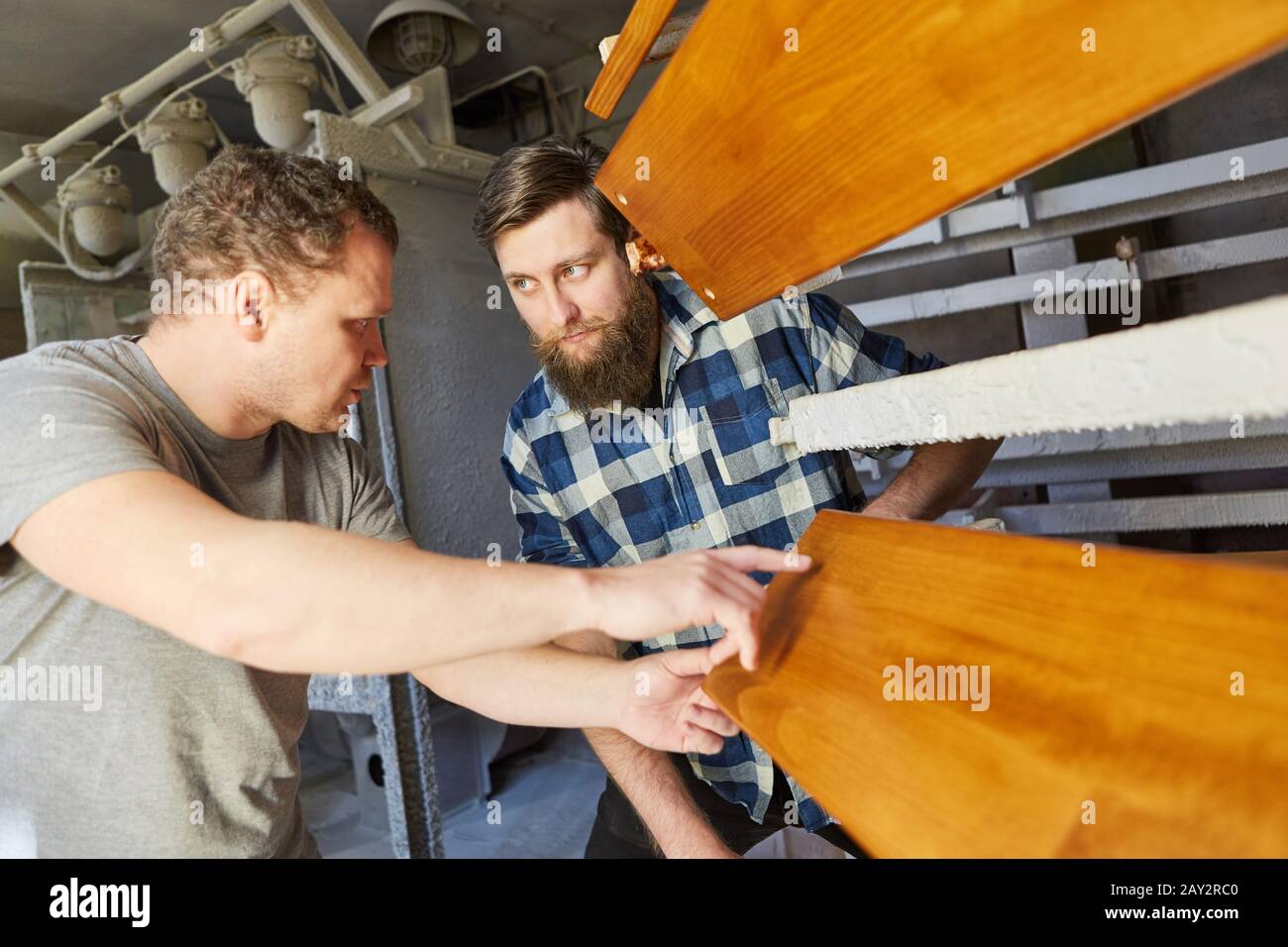 Carpenters and interns check the quality of wood protection or paint on the board Stock Photo