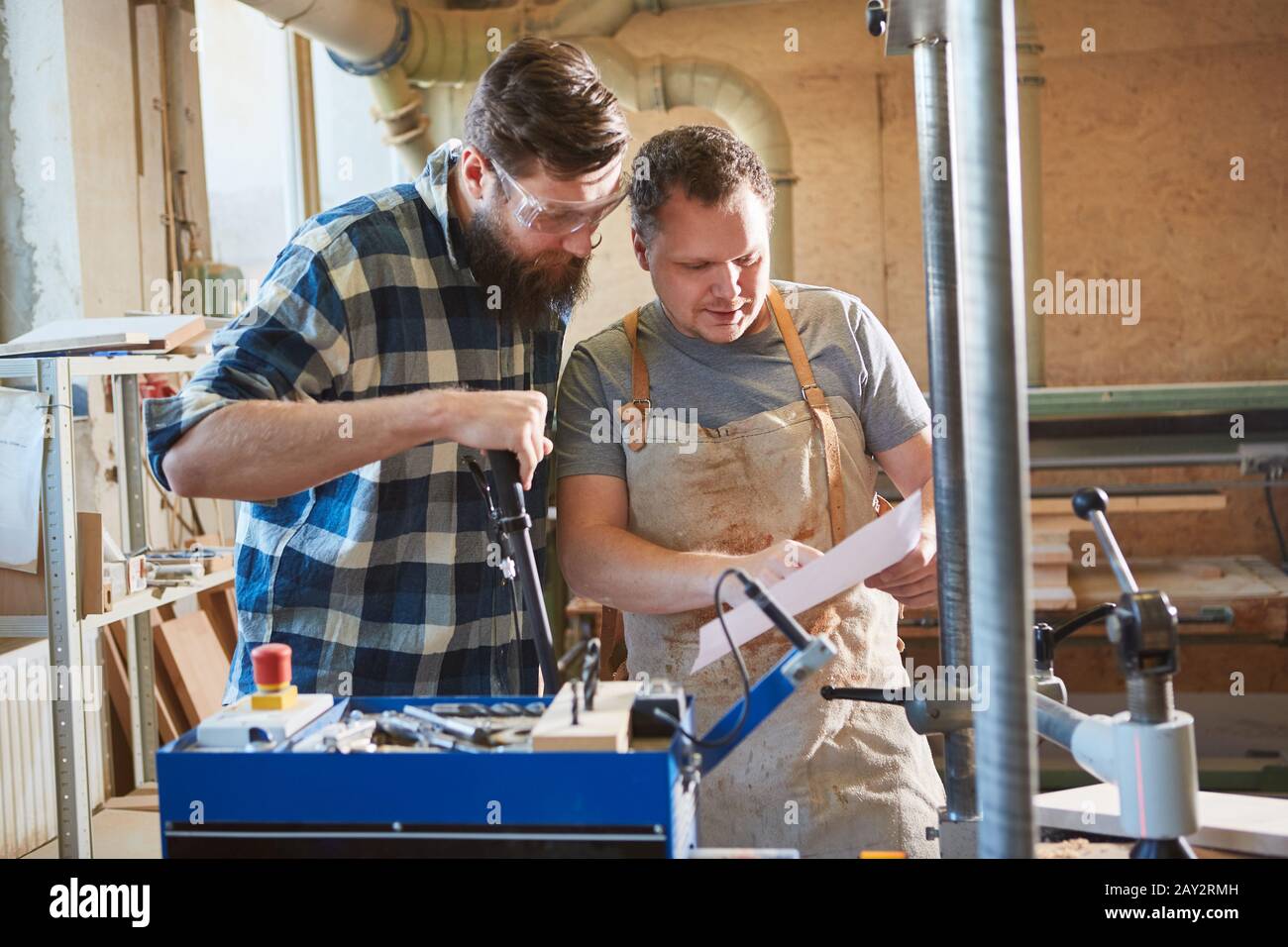 Two carpenters check a checklist for a carpentry job Stock Photo