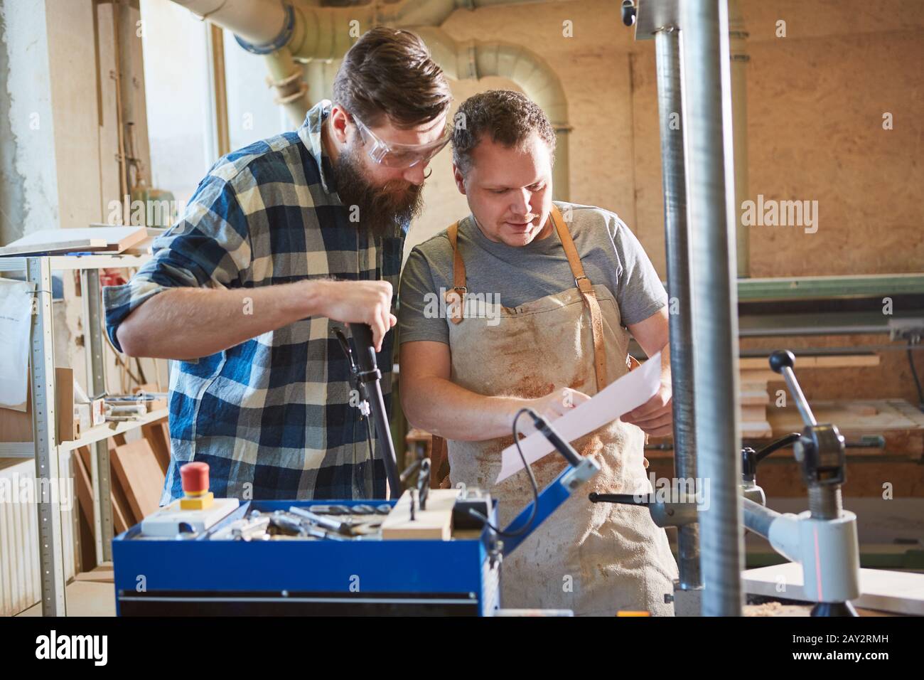 Two carpenters check a checklist for a carpentry job Stock Photo Alamy