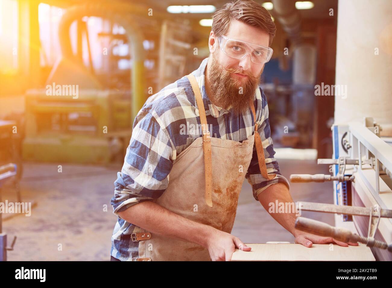 Hipster with a beard is training as a carpenter Stock Photo