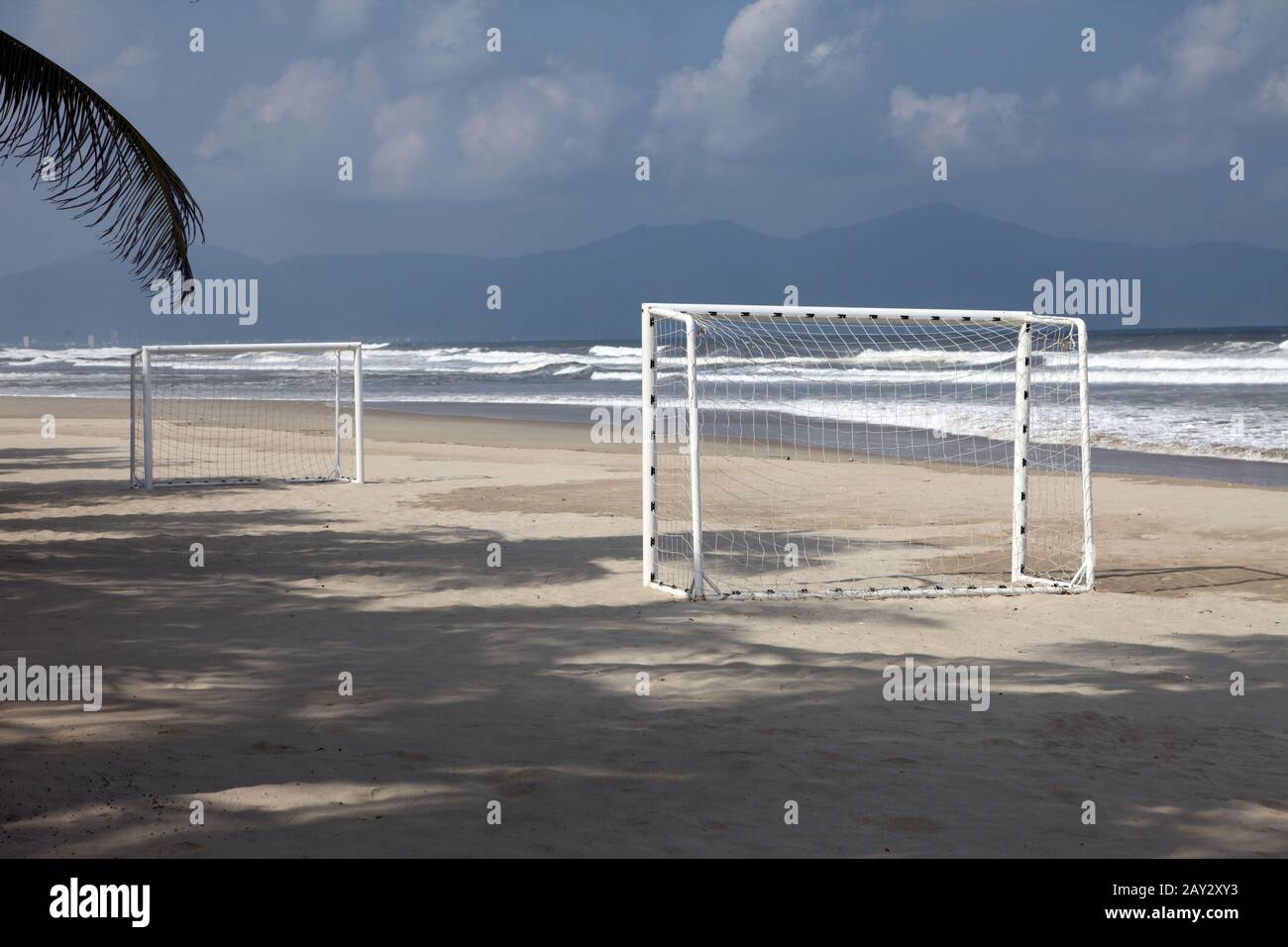 empty goal of a football or soccer playroung on the beach near the see on thesand Stock Photo
