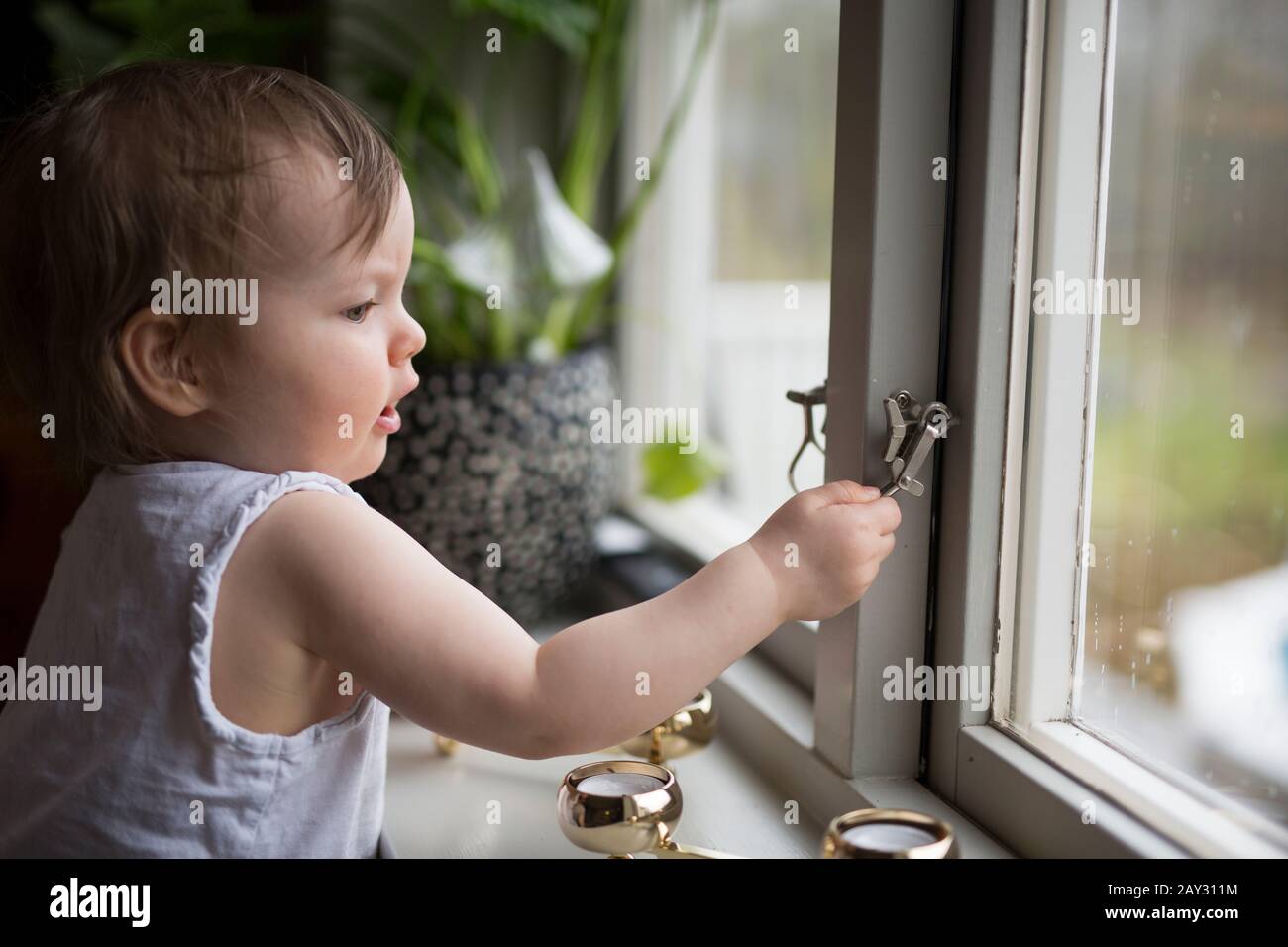 Boy looking out of window Stock Photo