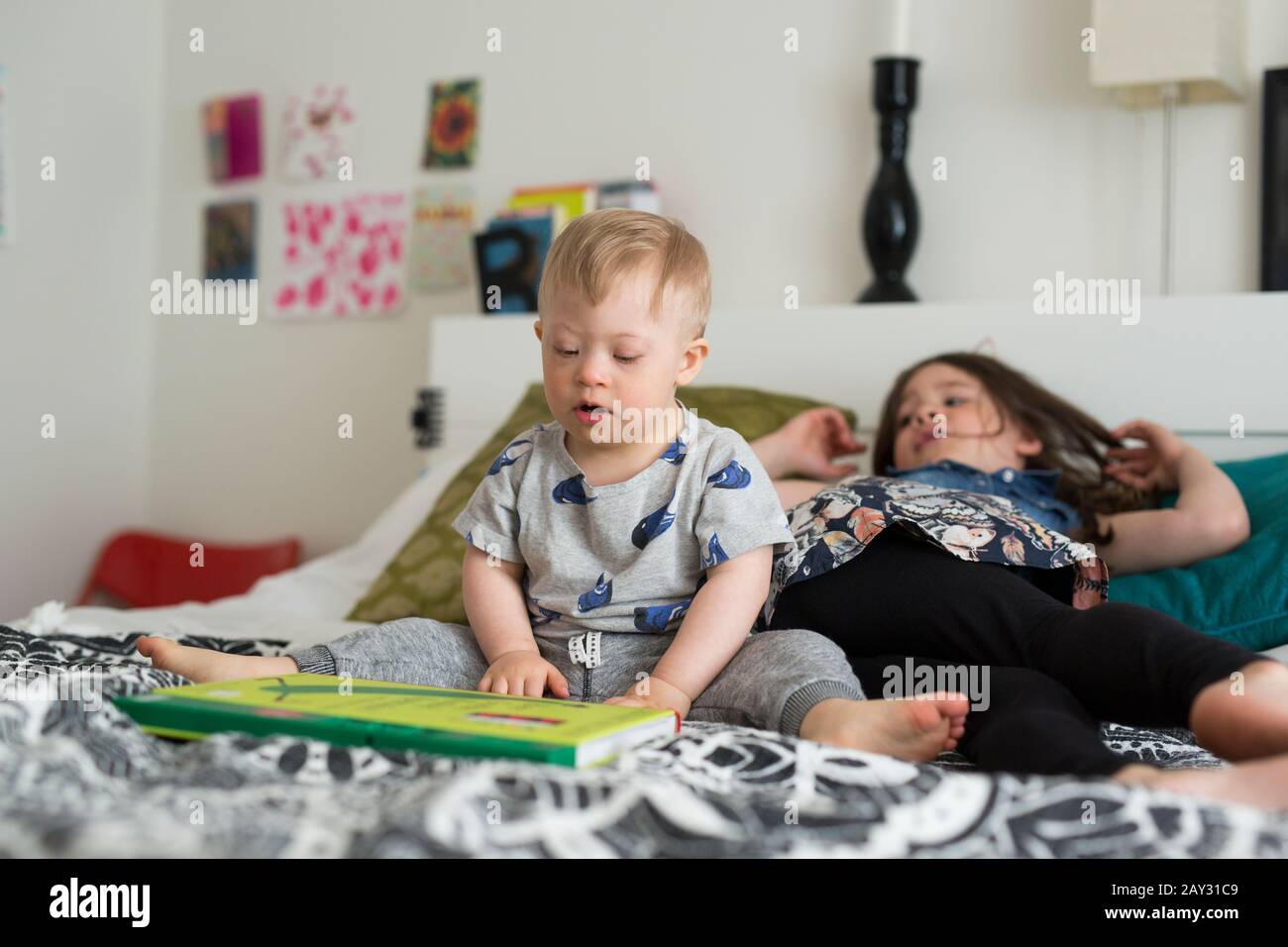 Brother and sister on bed Stock Photo