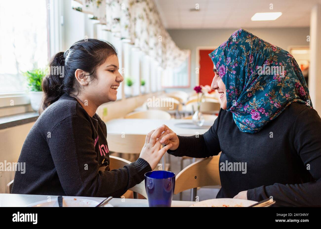 Smiling girls in school canteen Stock Photo Alamy