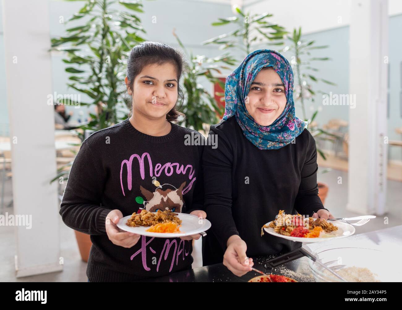 Smiling girls in school canteen Stock Photo Alamy