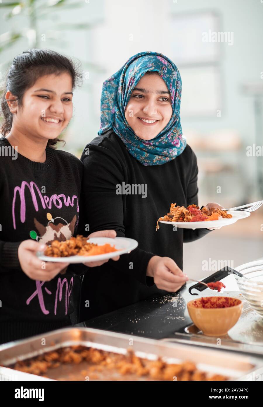 Smiling girls in school canteen Stock Photo Alamy