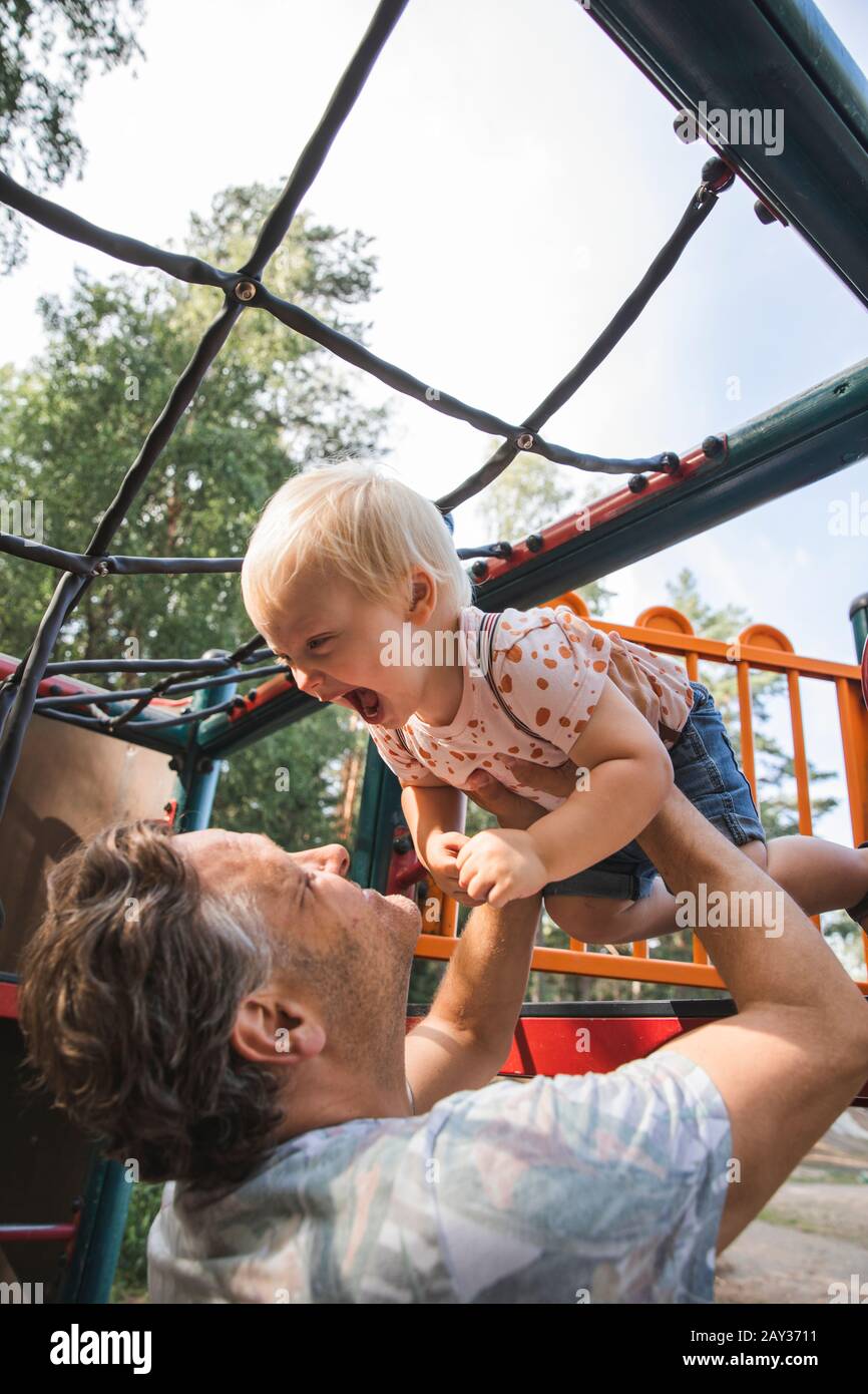 Father playing with son on playground Stock Photo