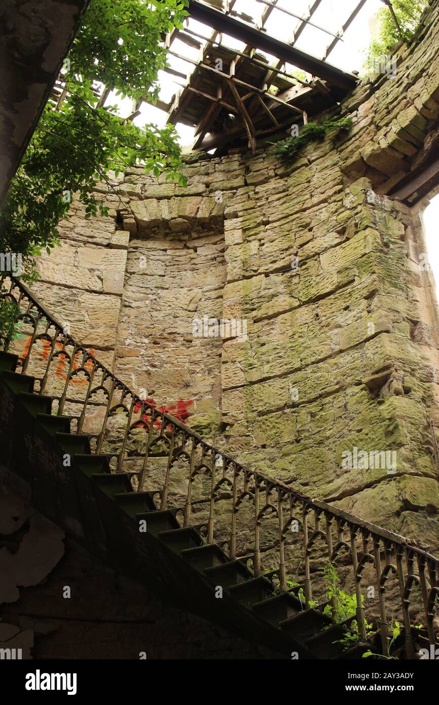 Spiral staircase of the abandoned gothic mansion Crawford Priory Stock Photo