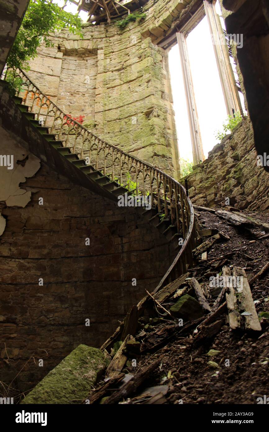 Spiral staircase of the abandoned gothic mansion Crawford Priory Stock Photo