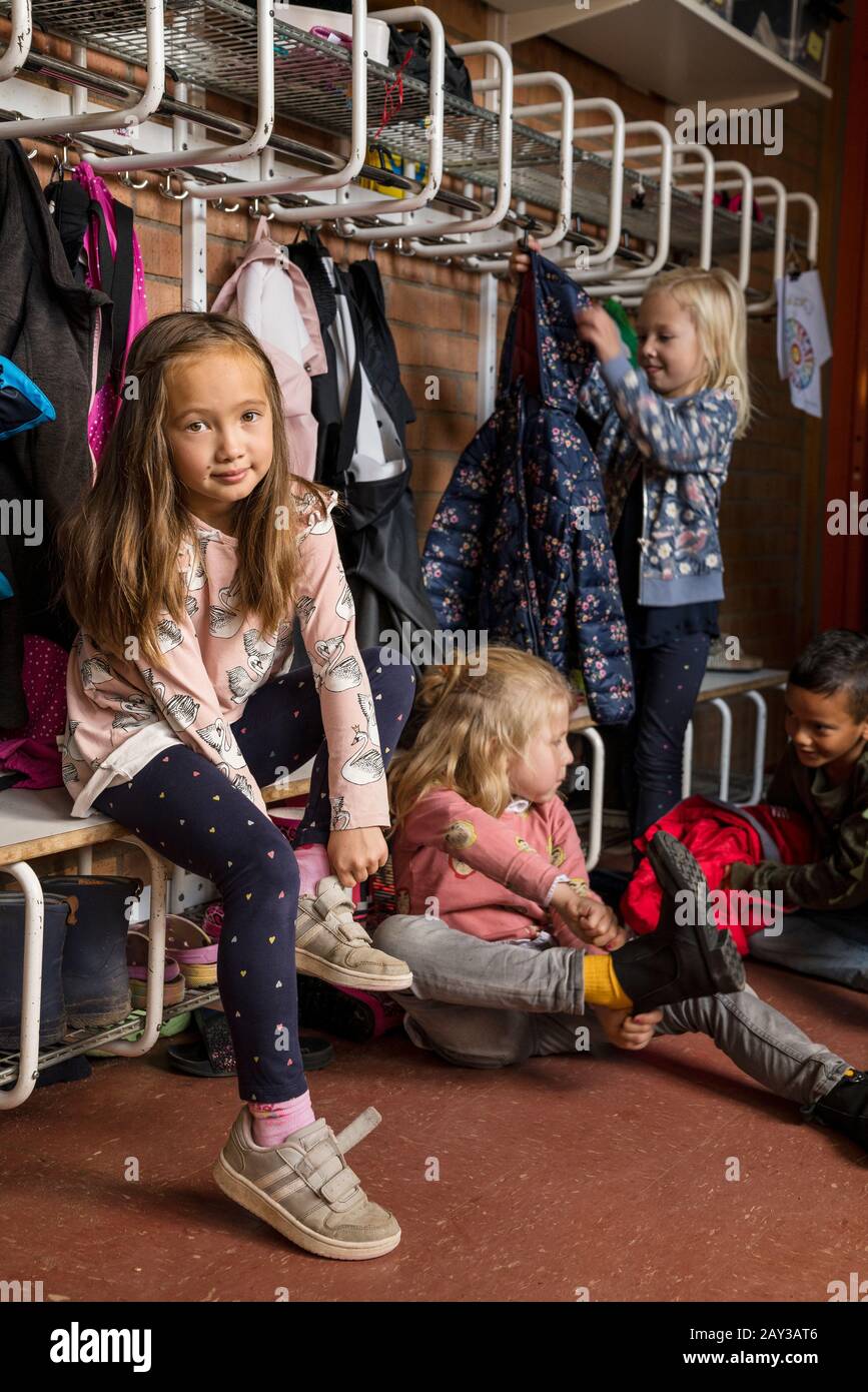 Children getting dressed at school Stock Photo
