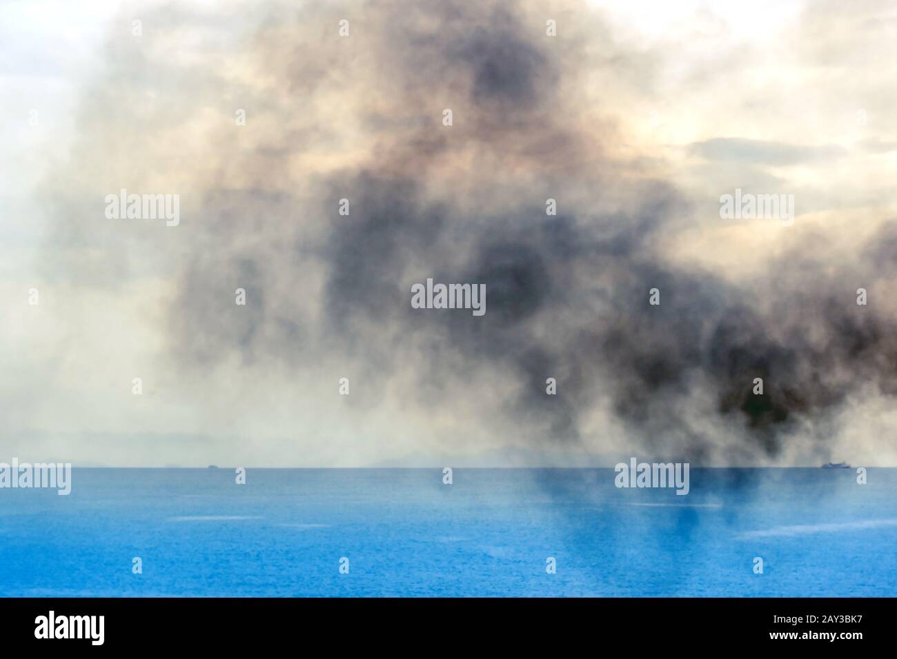 Exhaust pipe of ferry boat with black thick smoke coming out and sky ...