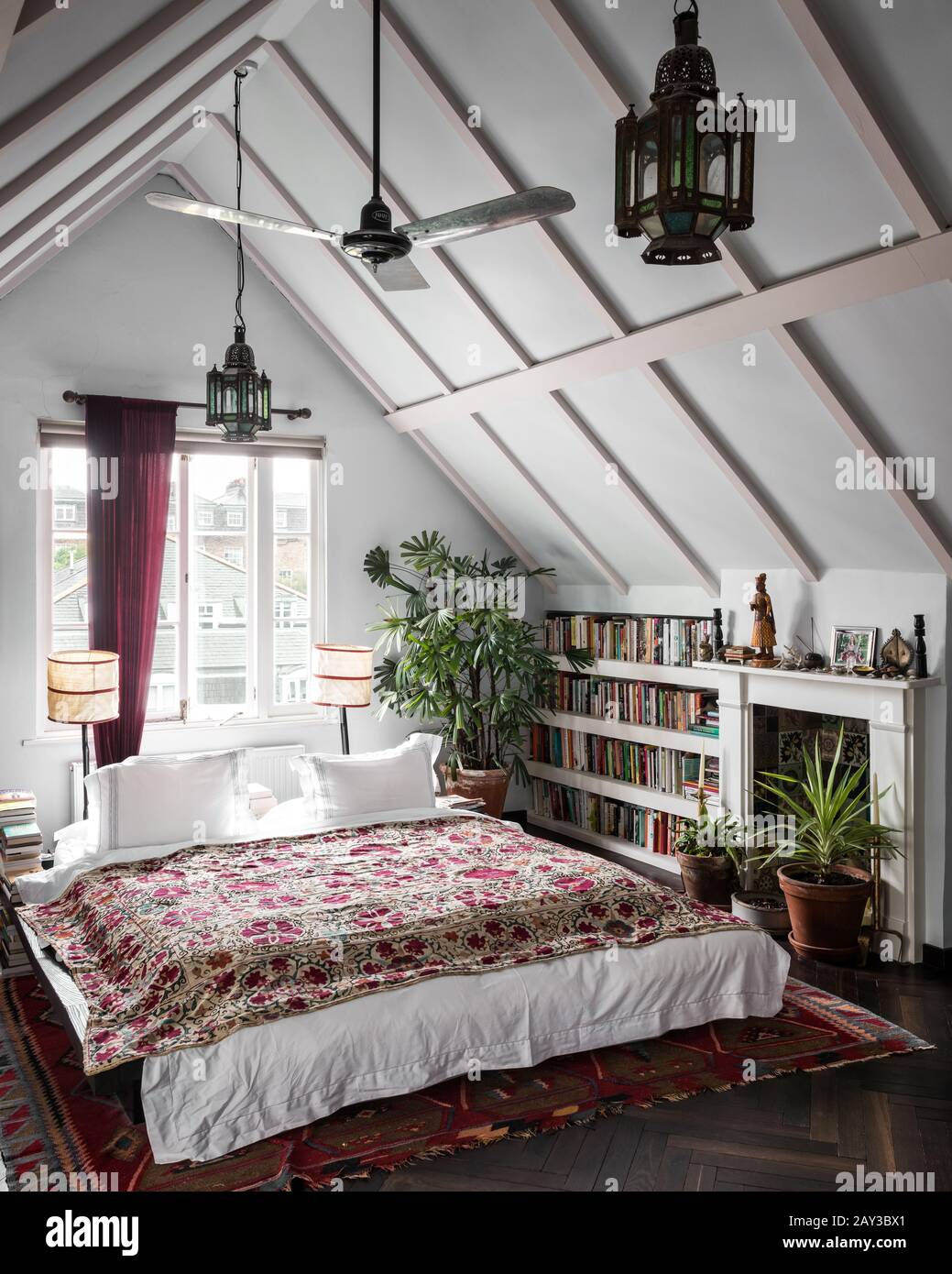 Double bed under gabled ceiling Stock Photo