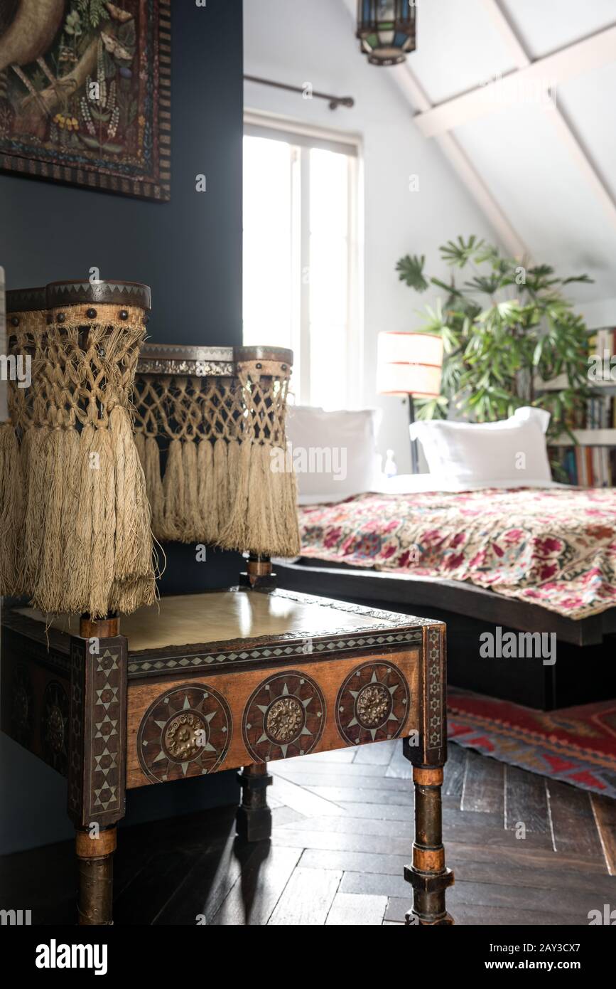Ethnic objects on table in bedroom Stock Photo