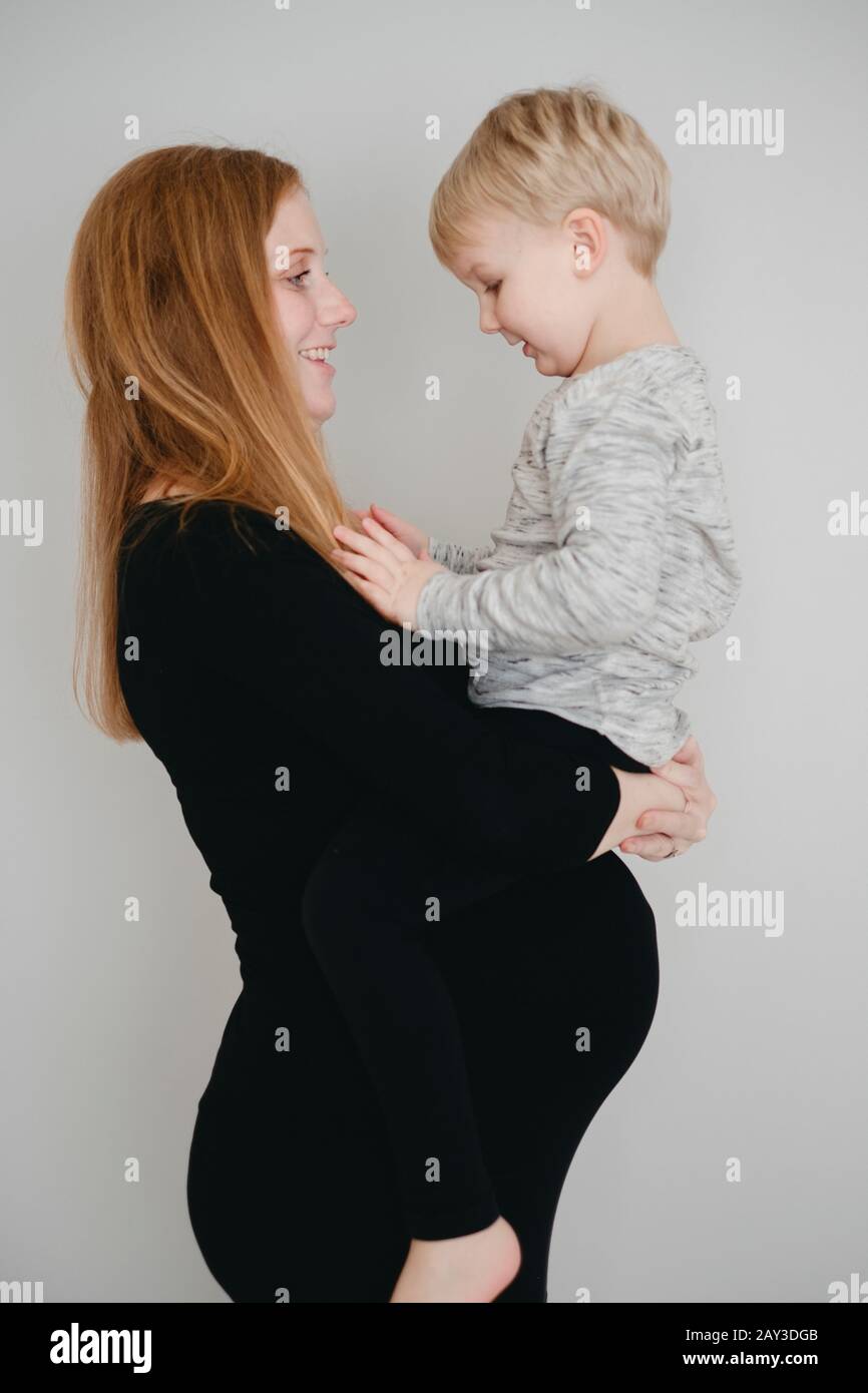 Mother carry son Stock Photo - Alamy