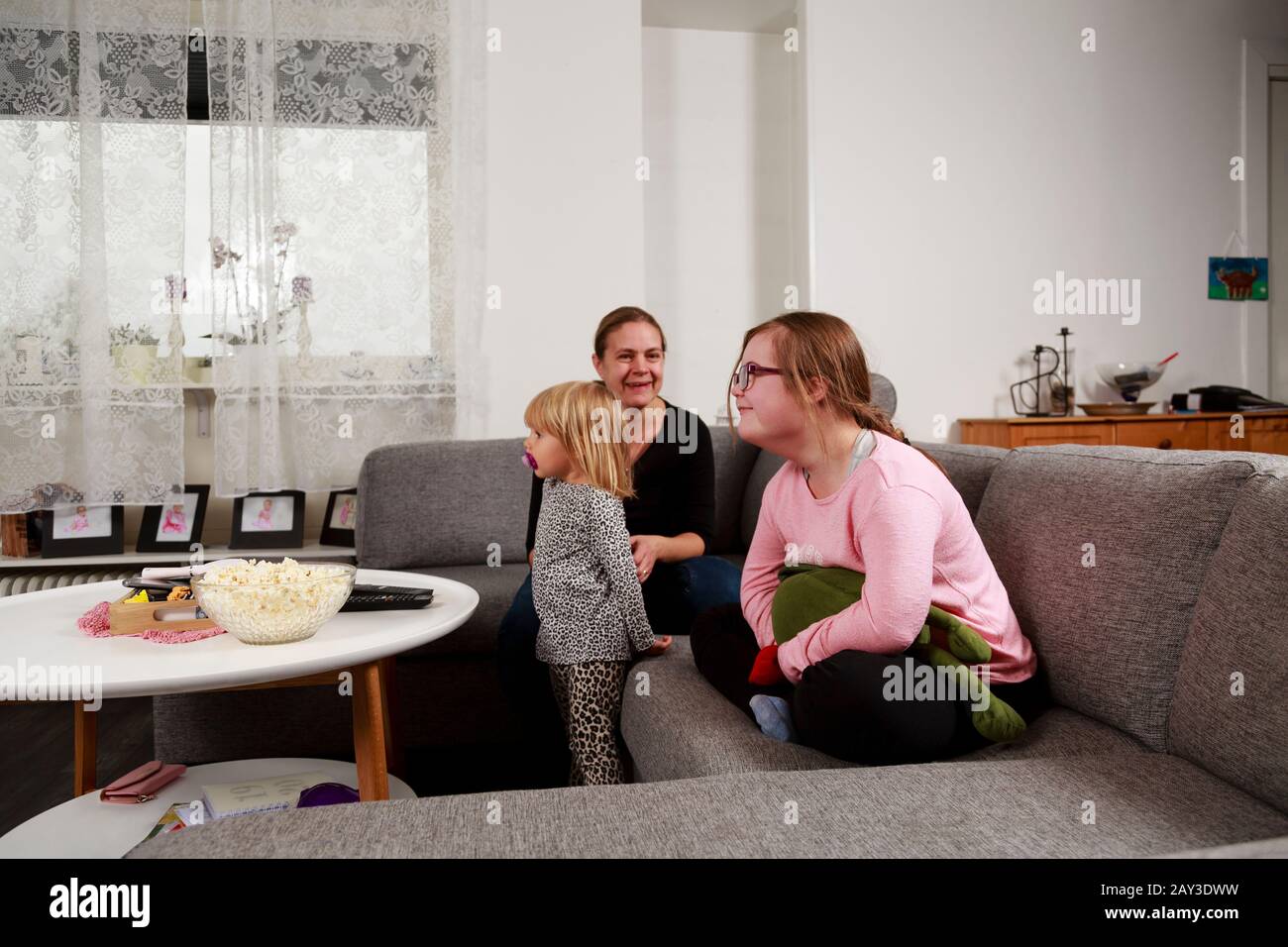 Mother with daughters on sofa Stock Photo