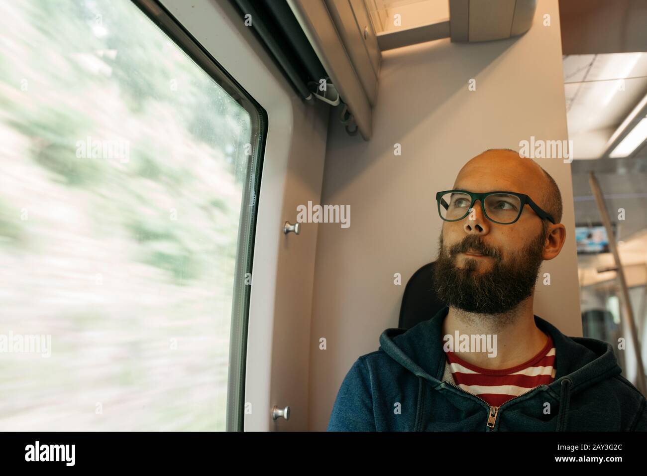 Man sitting in train Stock Photo