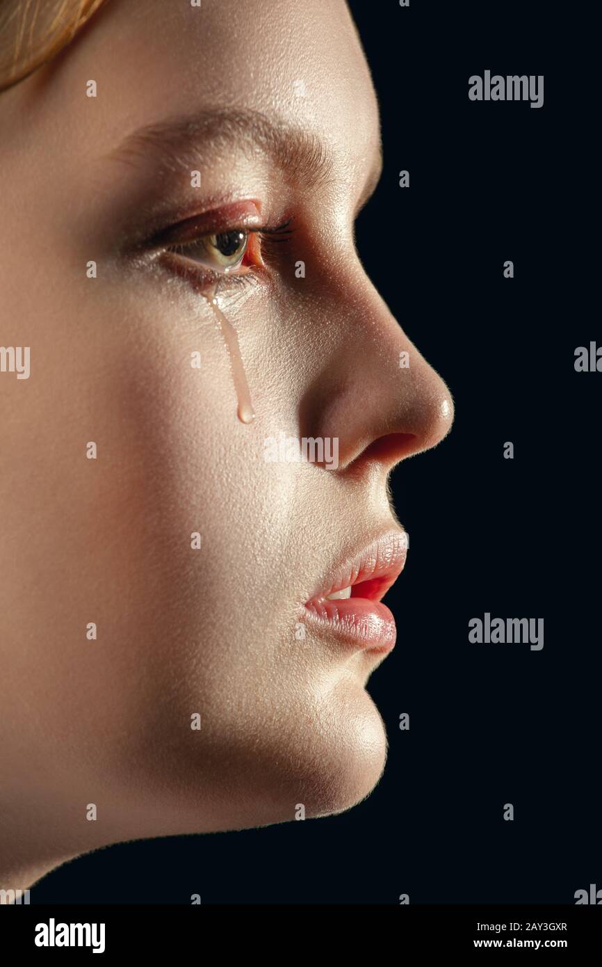 sad woman crying, looking aside on black background, closeup portrait,  profile view Stock Photo - Alamy