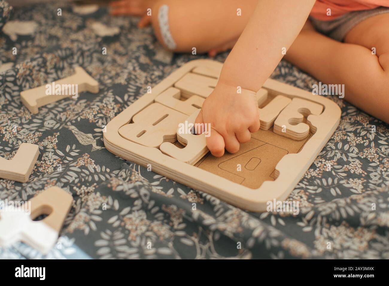 Child solving wooden puzzles Stock Photo