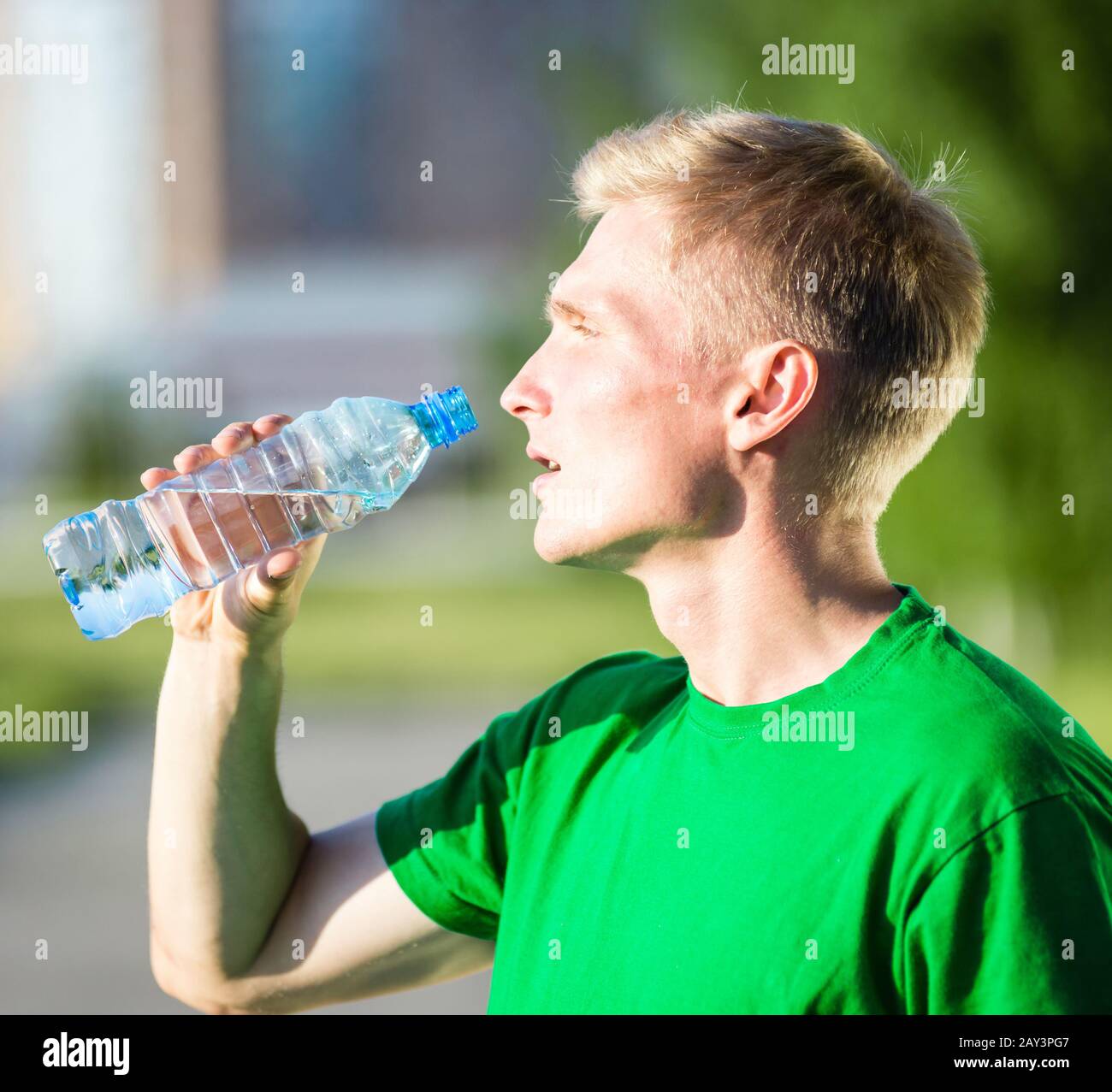 young man or teenager drinking water from bottle Stock Photo