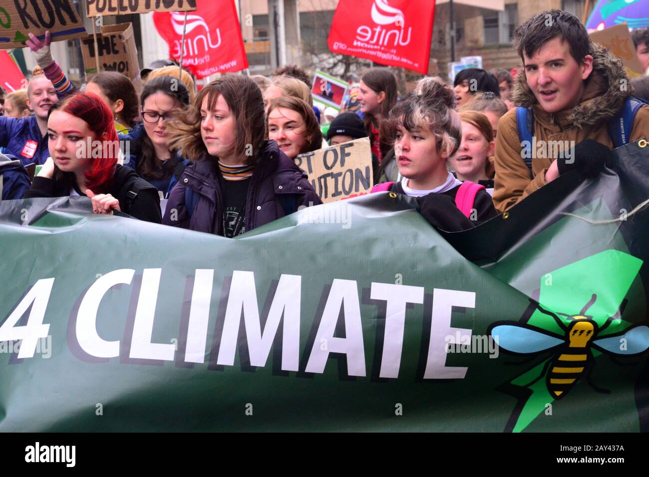 Young people march through city centre Manchester, United Kingdom, lobbying for action to prevent climate change at the  Youth Strike 4 Climate protest on 14th February, 2020, in Manchester, uk.  The organisers say: 'Student Climate Network (UKSCN) is a group of mostly under 18s taking to the streets to protest the government’s lack of action on the Climate Crisis. We are mobilising unprecedented numbers of students to create a strong movement and send a message that we are tired of being ignored.' Stock Photo