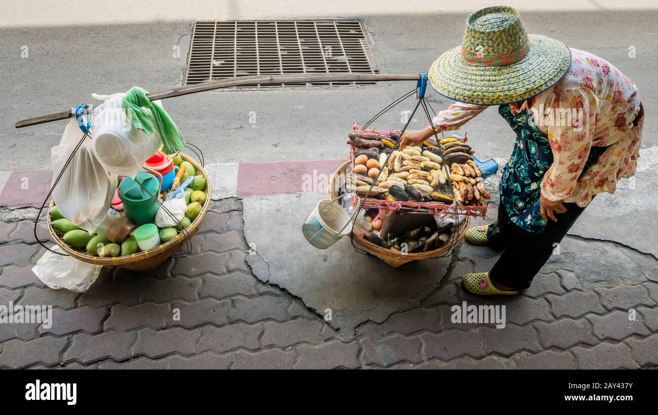 Street food vendor with shoulder pole for transportation in a central  district of Bangkok, Thailand Stock Photo - Alamy