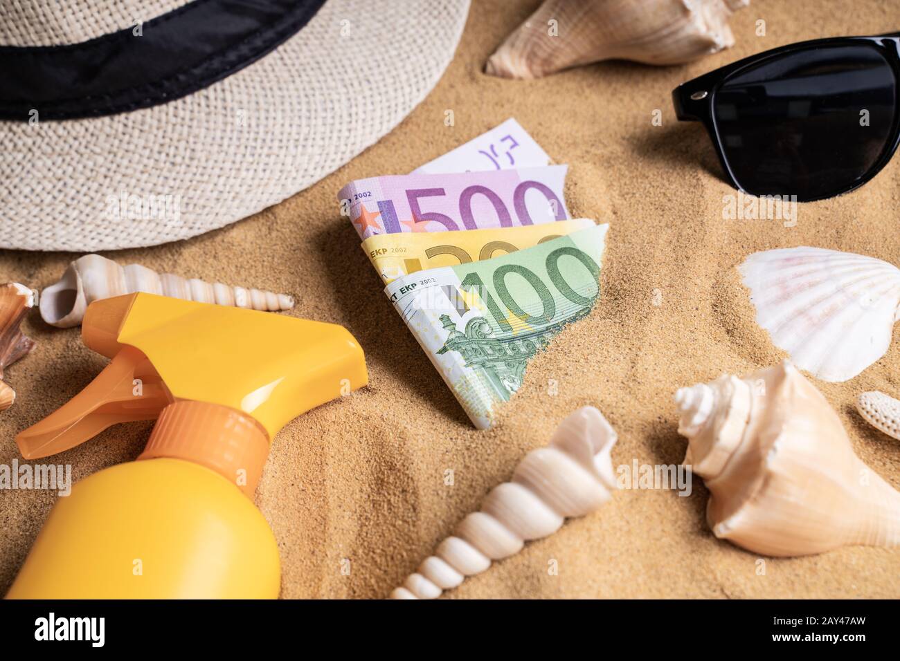 Euros In Sand On Beach Surrounded By Objects Stock Photo
