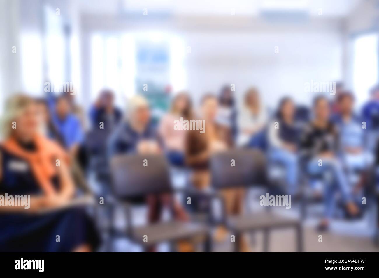 Blurred front view background classroom. High school or undergraduate student sitting on lecture chairs listening to speaker. Education concept Stock Photo