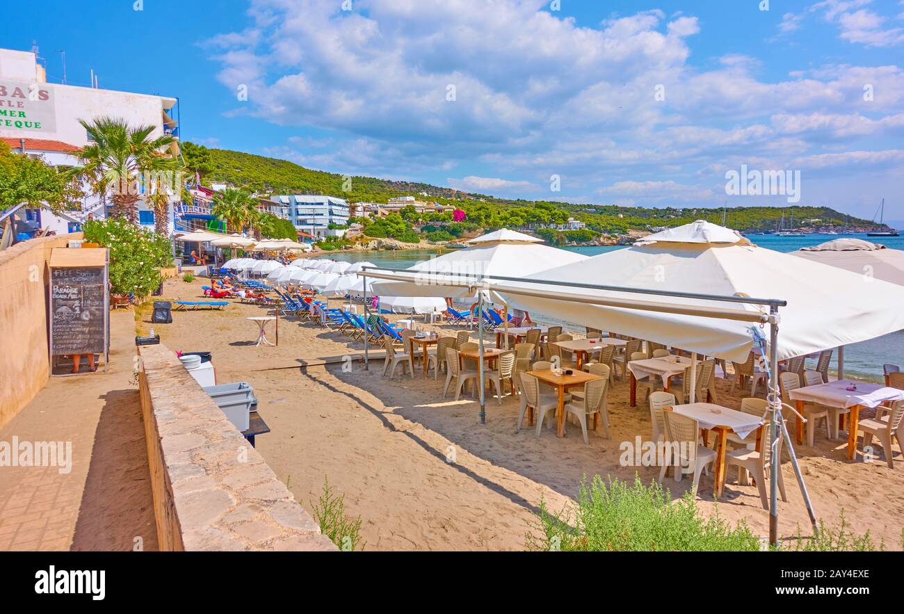 Agia Marina, Aegina Island, Greece  - September 13, 2019:  Beach with open air cafe in Agia Marina in Aegina Island Stock Photo