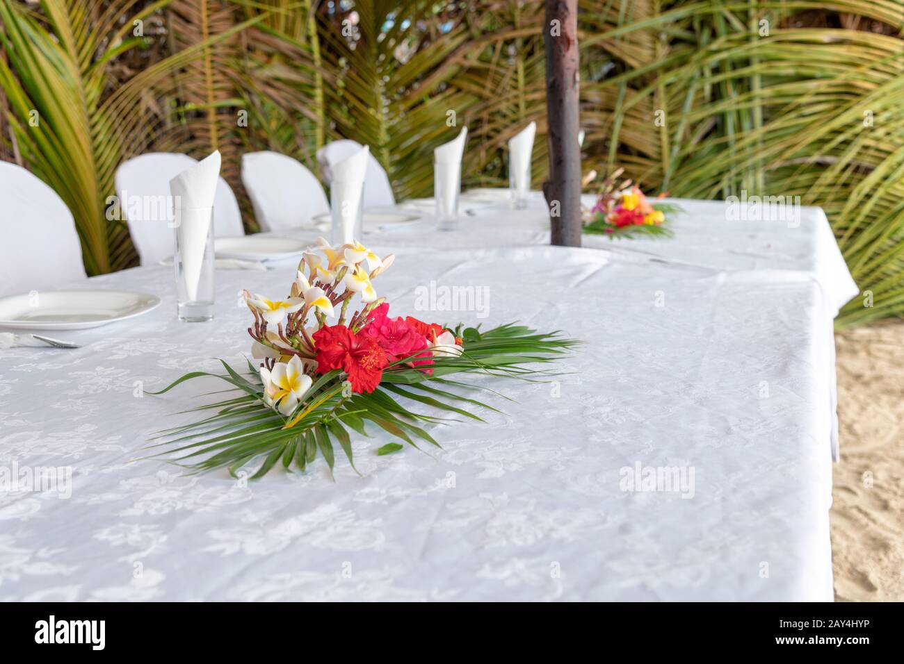 Set table with flowers on a beautiful beach. Stock Photo