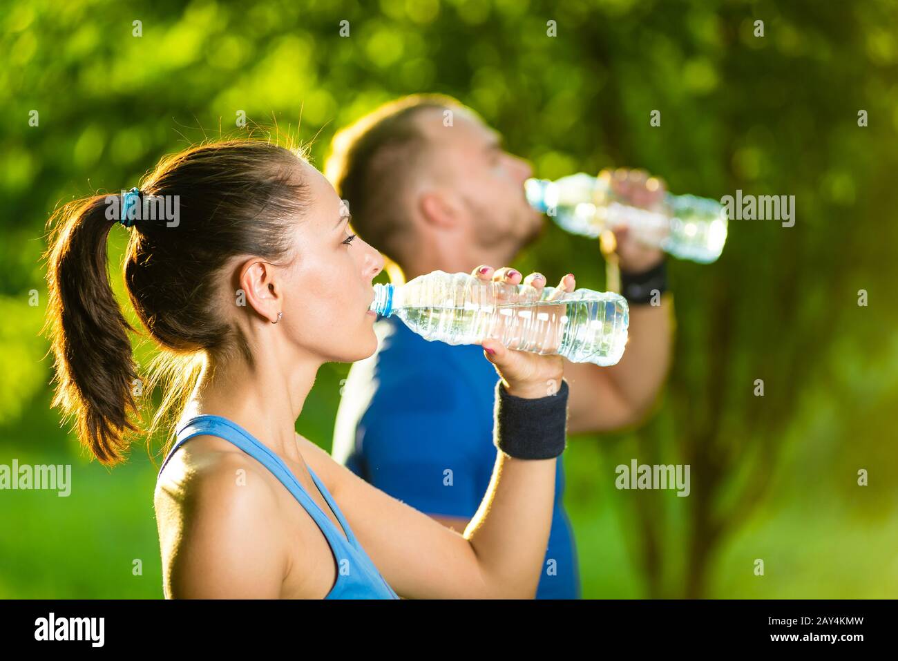 https://c8.alamy.com/comp/2AY4KMW/man-and-woman-drinking-water-from-bottle-after-fitness-sport-exercise-2AY4KMW.jpg