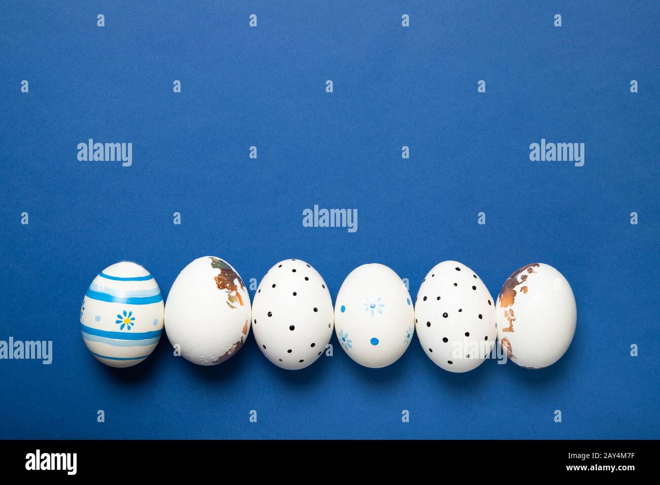Easter eggs on a blue background, Place for text, Top view, Stock Photo
