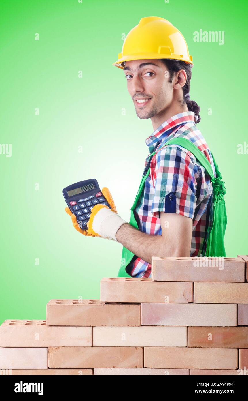 Expensive construction concept with builder and calculator Stock Photo
