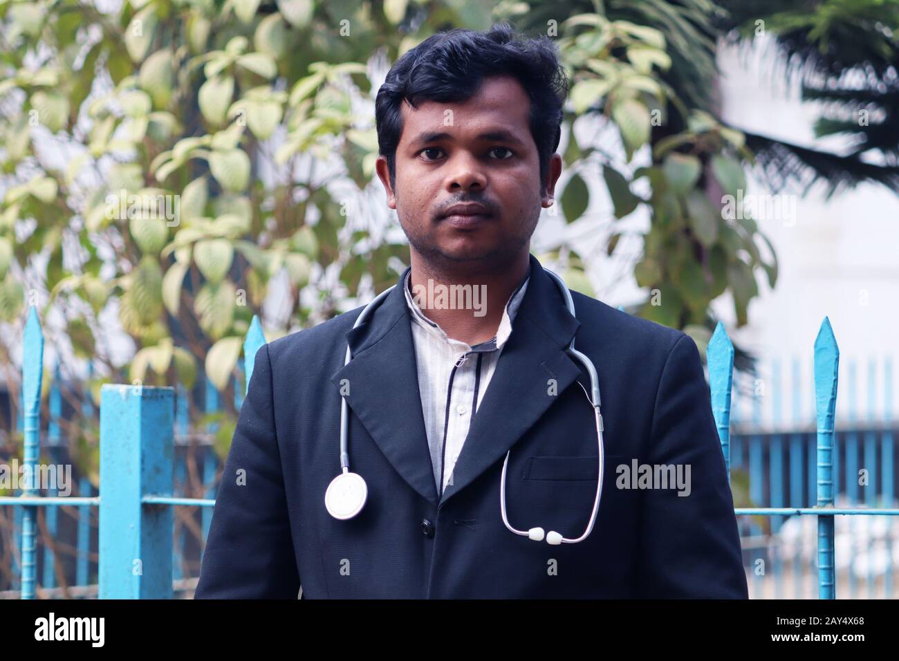 Young Doctor with Black Coat and Diamond Blood Pressure Machine. Healthcare and medical concept. Homeopathy Doctor Treatment in Asia. Dr Hafizul Islam Stock Photo