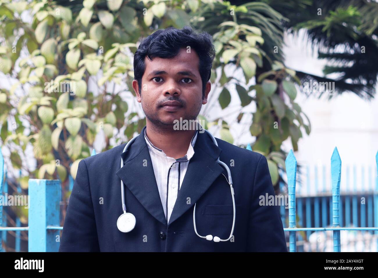 Young Doctor with Black Coat and Diamond Blood Pressure Machine. Healthcare and medical concept. Homeopathy Doctor Treatment in Asia. Dr Hafizul Islam Stock Photo