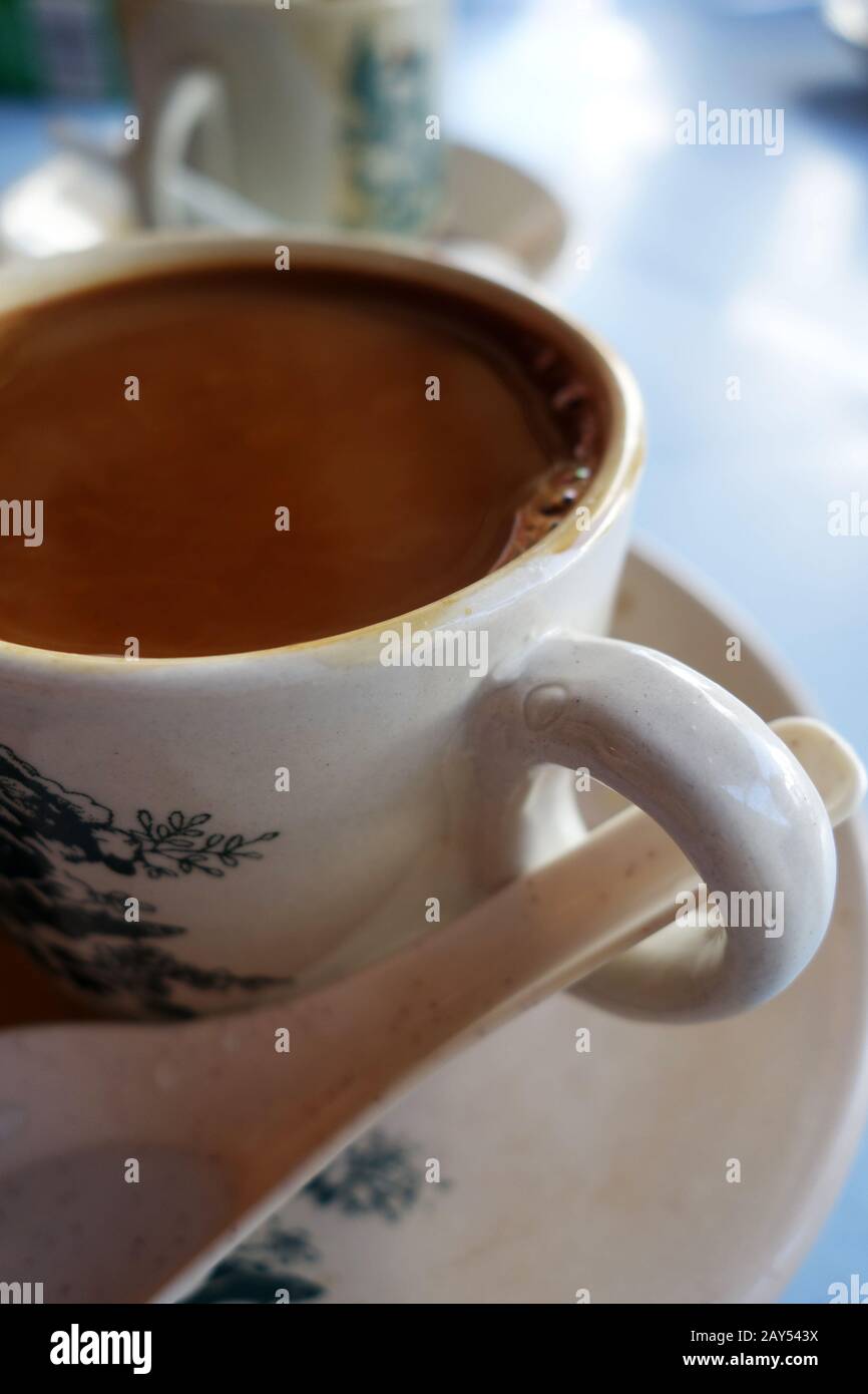 Traditional oriental Chinese coffee in vintage mug and saucer Stock Photo