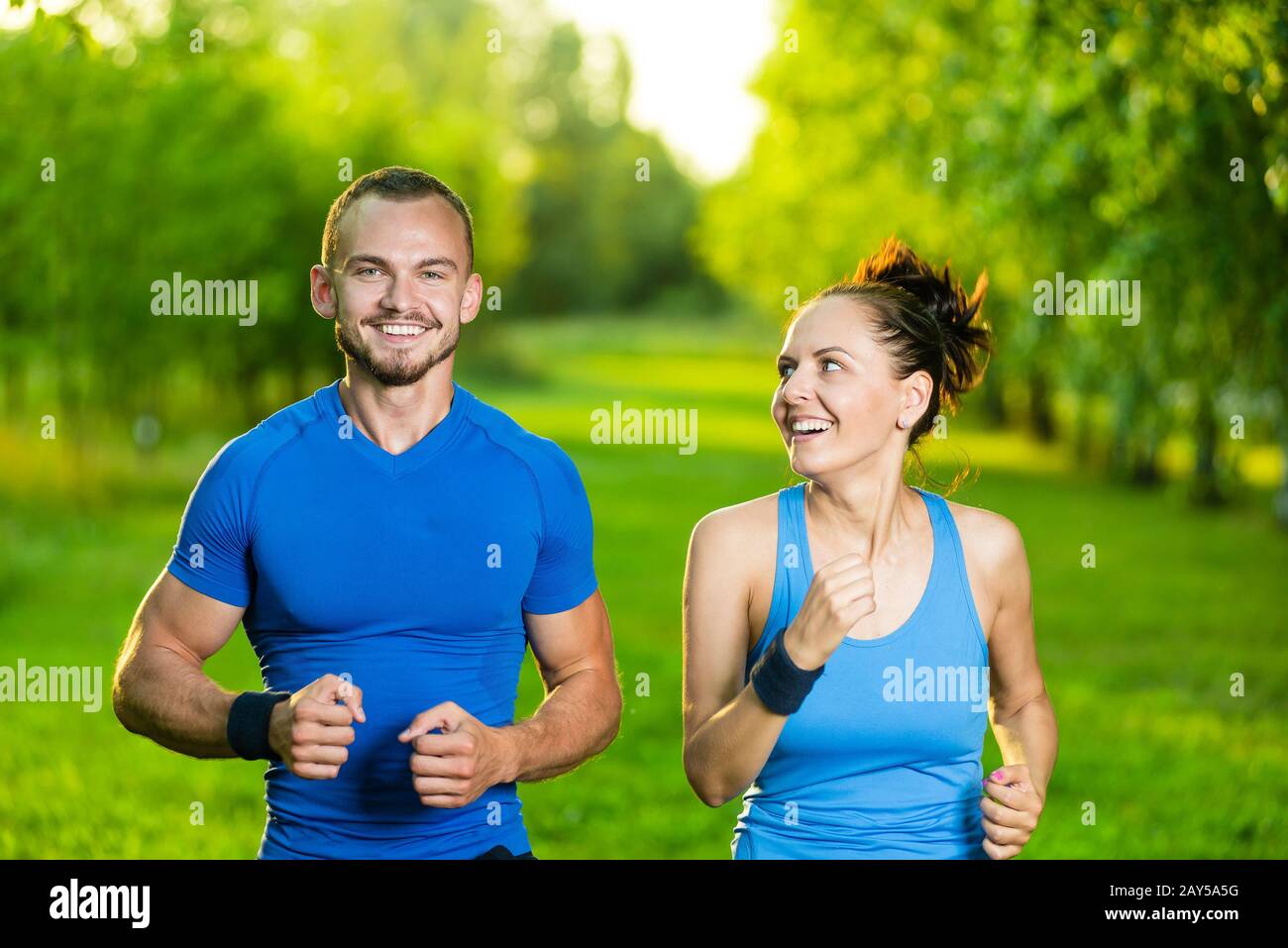 Runners training outdoors working out. City running couple jogging outside. Stock Photo