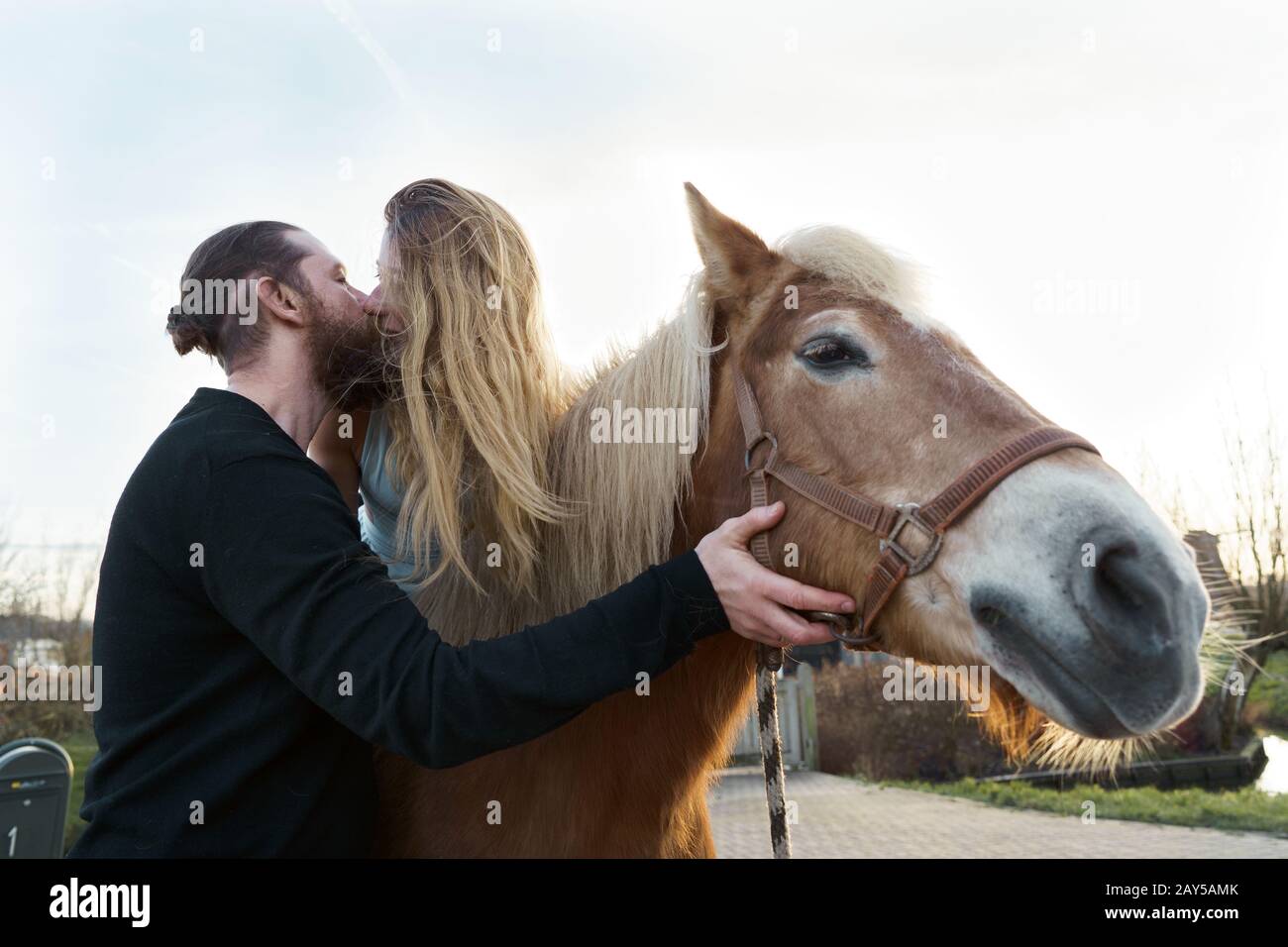Loving couple man and woman Kissing Riding a Horse Stock Photo