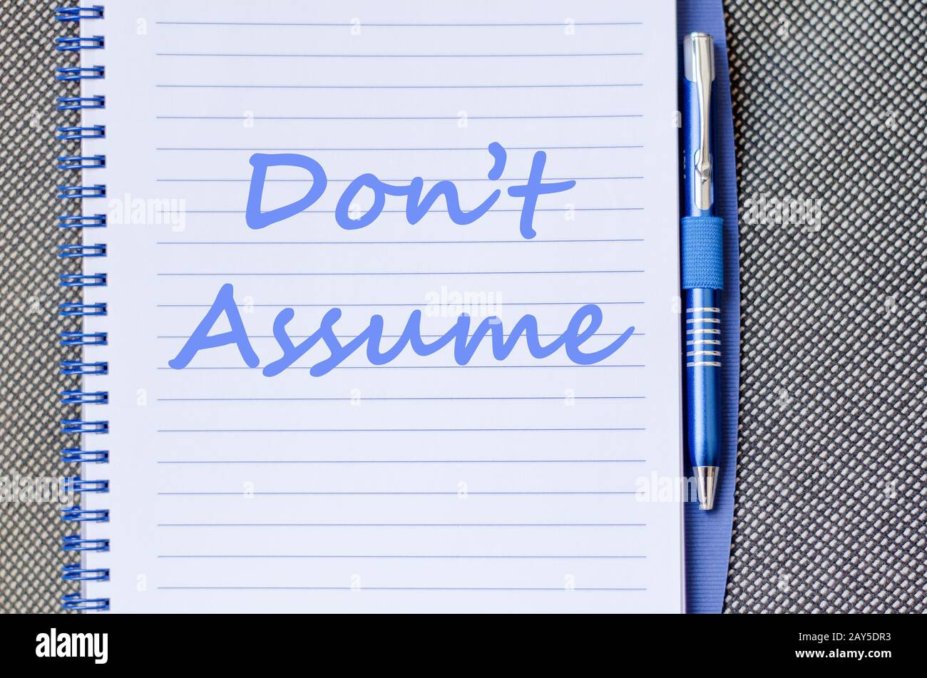 Don't assume write on notebook Stock Photo - Alamy