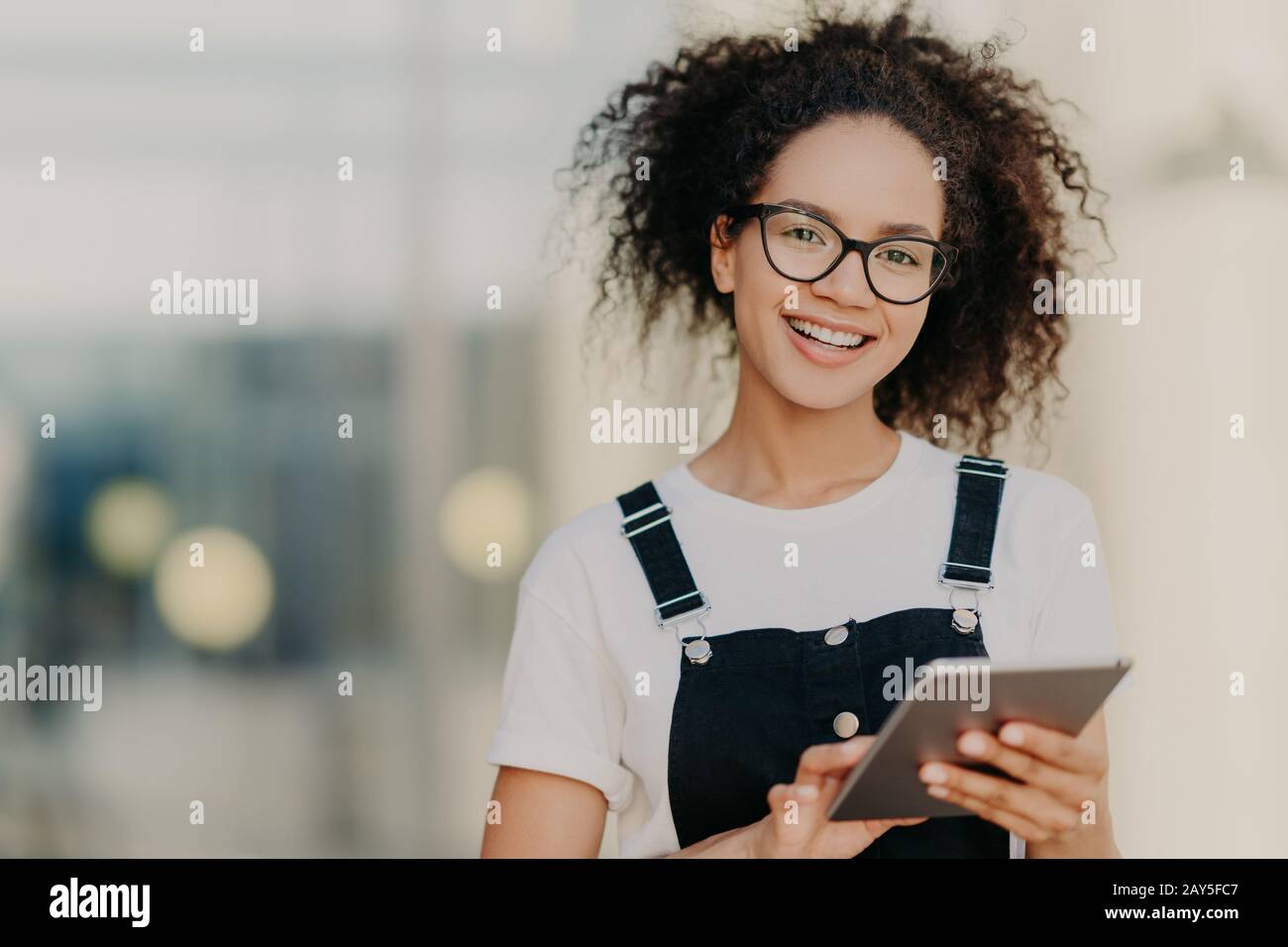 Lovely dark skinned ethnic woman with crisp hair combed in pony tail