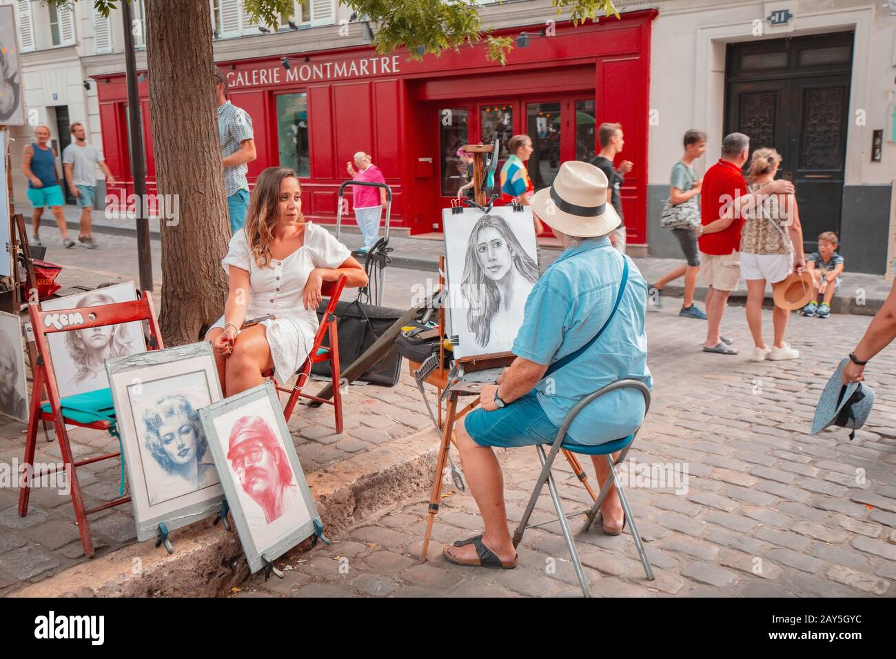 25 July 2019, Paris, France: Street artist painting girl portrait at the Montmartre street Stock Photo