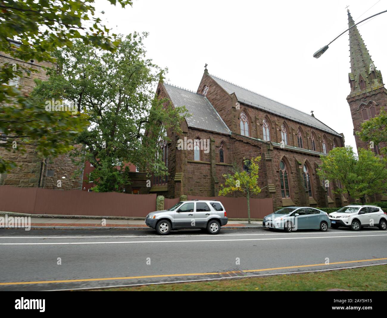 Newport, Rhode Island-September 2017: Cars parked on the curb behind St. Mary's Church in Newport. Stock Photo