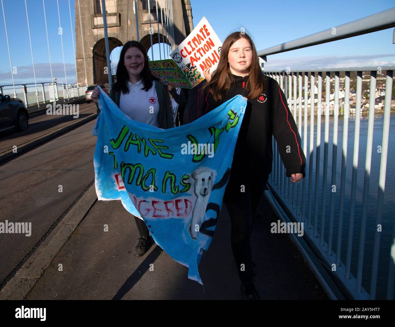 Young people carrying banners on Menai Bridge as part of the youth climate strike 2019 Stock Photo