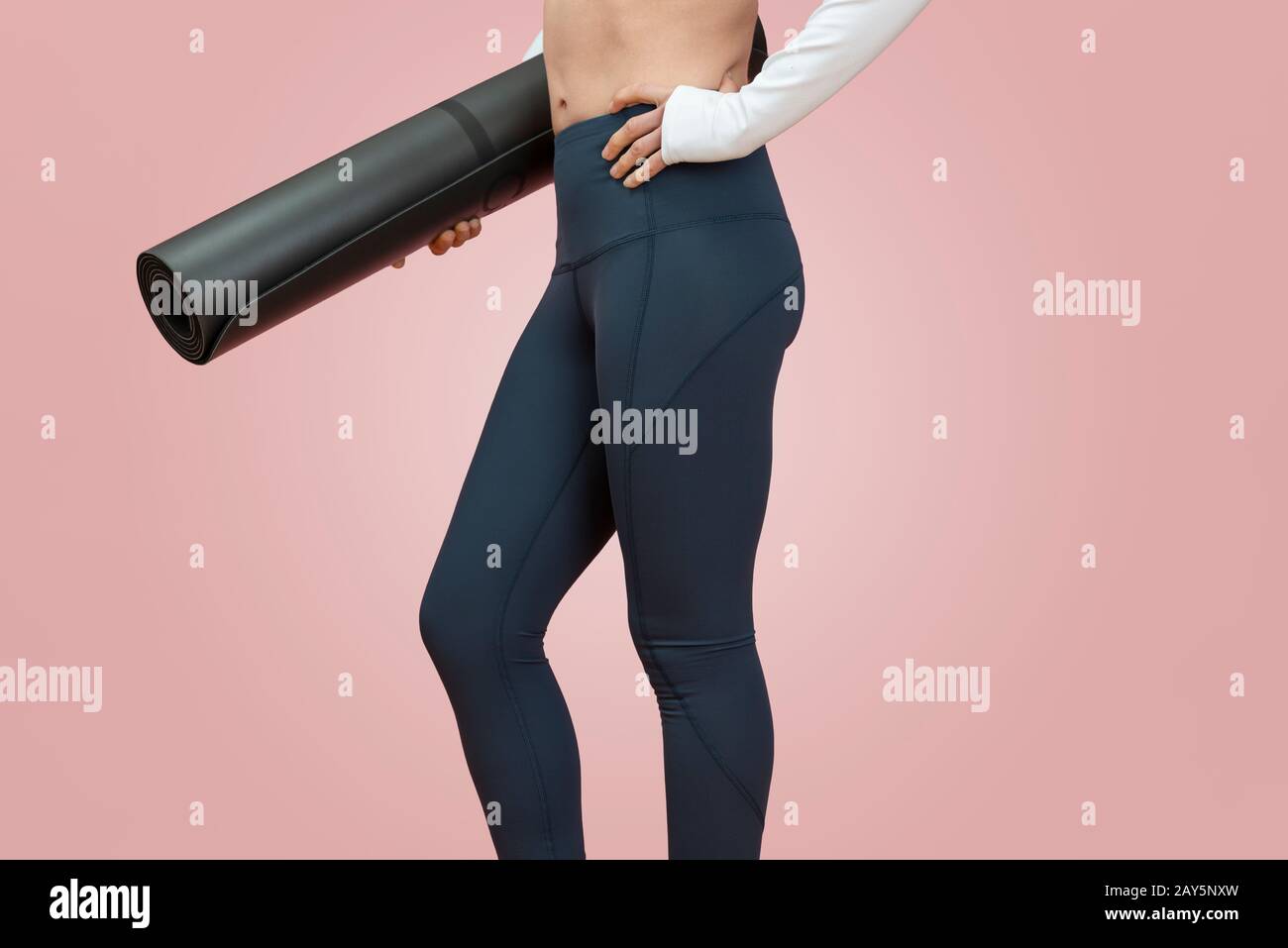 close up of a fit sporty woman carrying an exercise mat, healthy lifestyle concept. Stock Photo